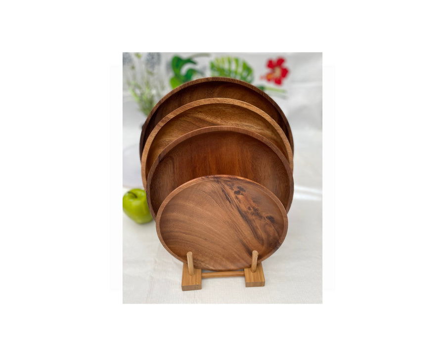 set of acacia wood round plates on a table