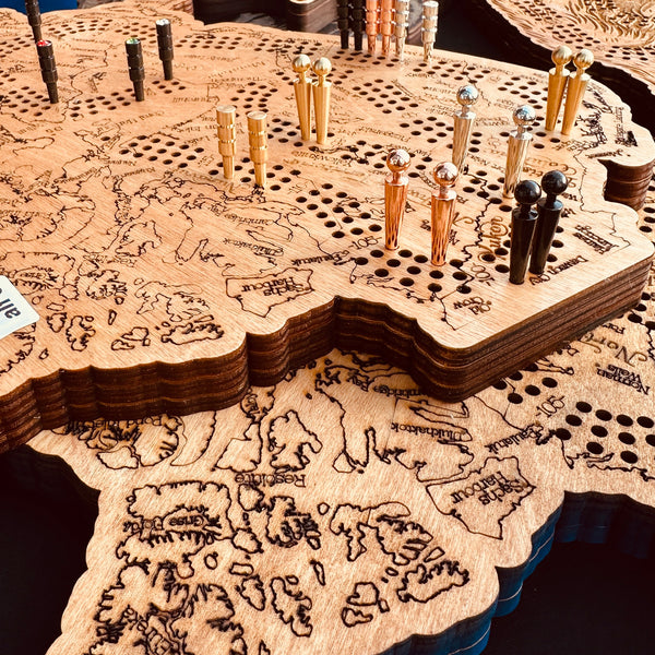 Wooden map Cribbage Board on table with metal pegs on top