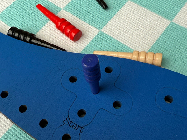 Blue peg boards setup  on a checkered floor