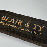Black cribbage Board with text on a white