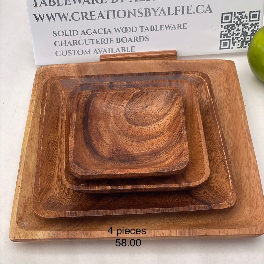 set of acacia wood round plates on a table