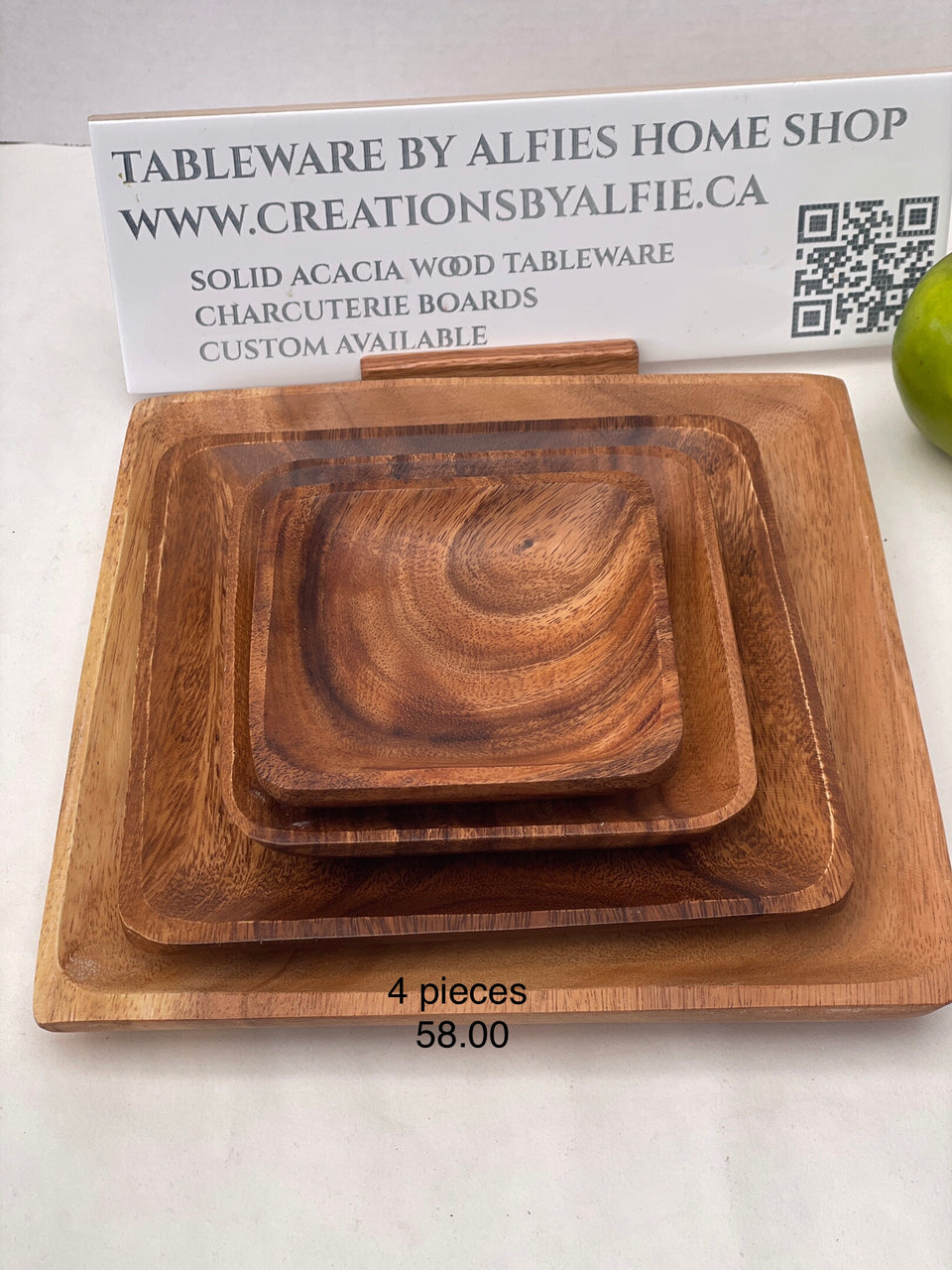 set of acacia wood round plates on a table