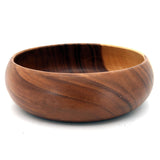 Wooden bowl with a brown and black striped pattern on a white background