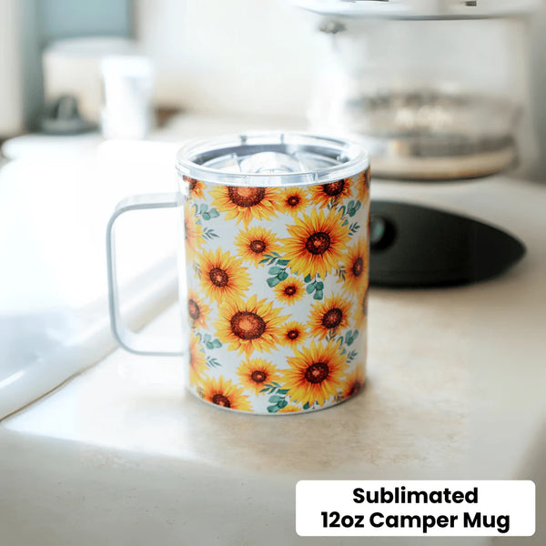 Sunflower-patterned sublimated 12oz camper mug on a kitchen counter.