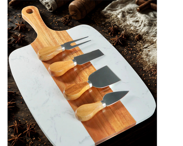 Marble cutting board with wooden handles and four cheese tools on a rustic background