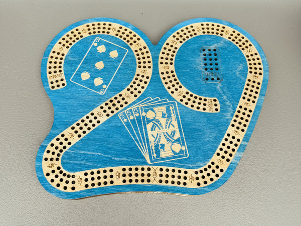 Blue cribbage board with playing card designs on a gray background