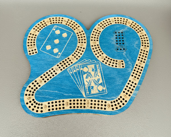 Blue cribbage board with playing card designs on a gray background