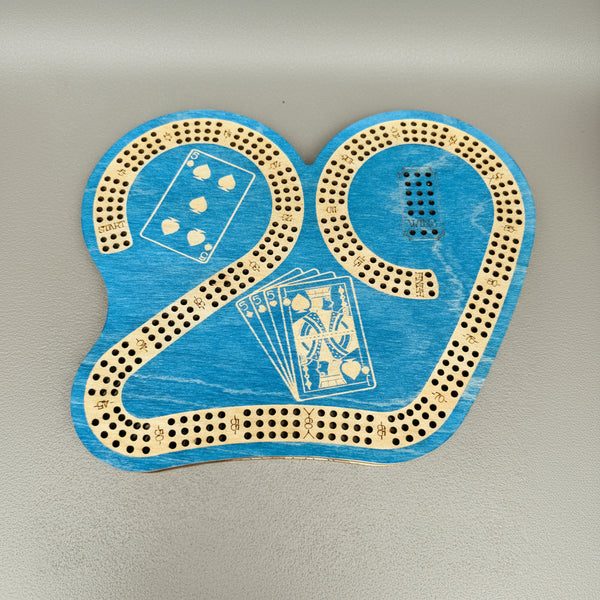 Blue cribbage board with playing card designs on a gray background