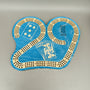 Blue cribbage board with playing card designs on a gray background