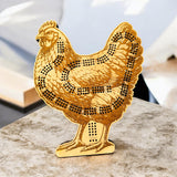 Gold chicken-shaped decorative item on a marble surface