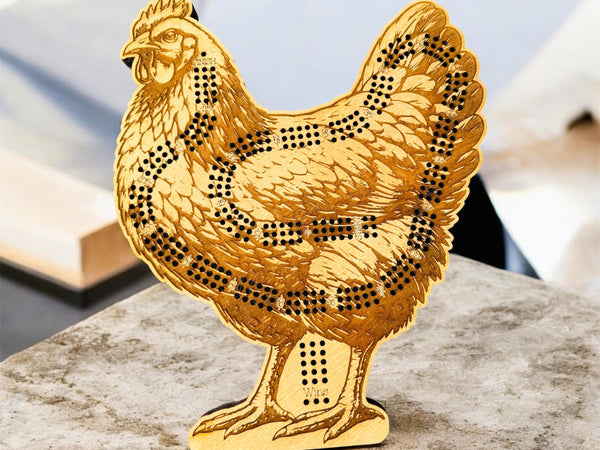 Gold chicken-shaped decorative item on a marble surface