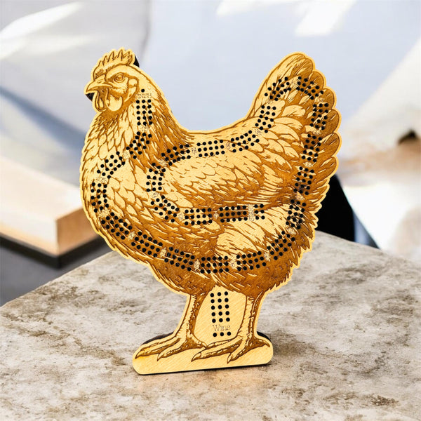 Gold chicken-shaped decorative item on a marble surface