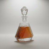 Crystal decanter with geometric design on a white background