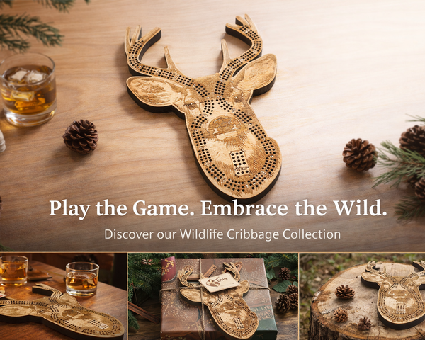 Wooden deer-shaped cribbage board on a wooden surface with glasses and cards, surrounded by pine cones and branches.