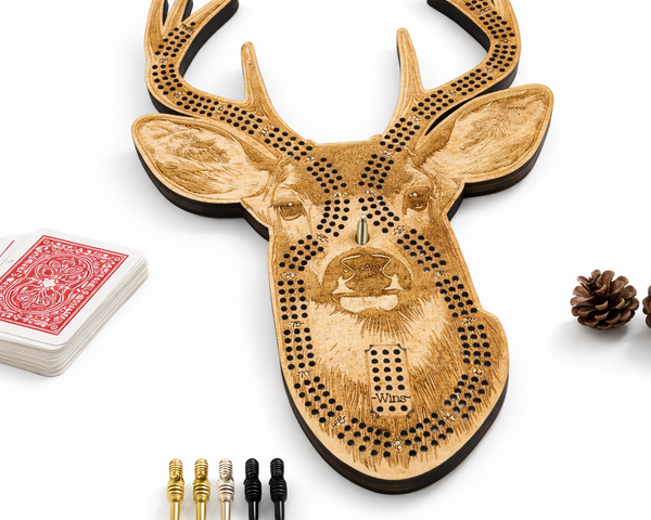 Wooden deer head cribbage board with playing cards and pegs on a white background