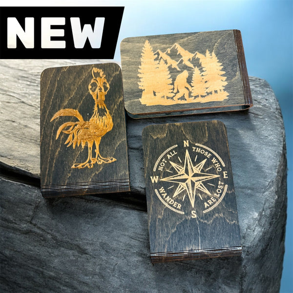 Wooden cards with engraved designs on a stone surface