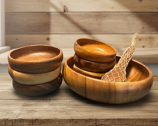 Set of wooden bowls on a wooden surface with a wooden wall background