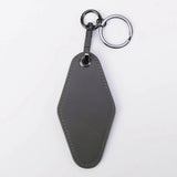 Gray leather keychain on a white background