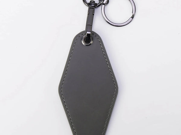 Gray leather keychain on a white background