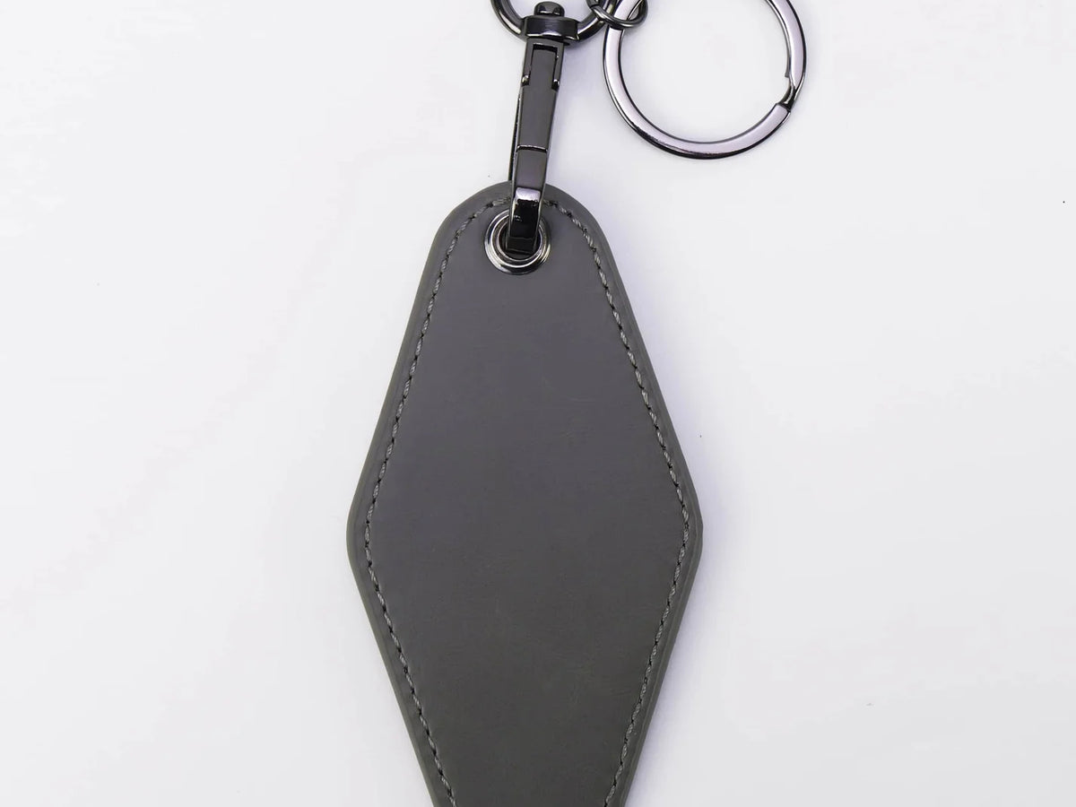 Gray leather keychain on a white background