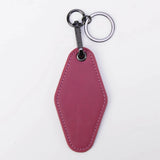 Pink leather keychain on a white background