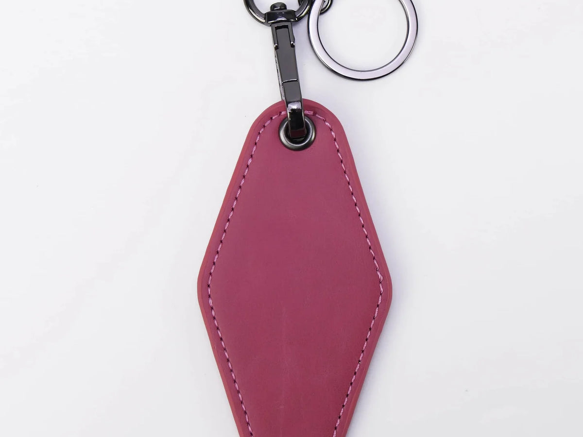 Pink leather keychain on a white background