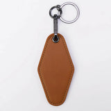Brown leather keychain with a metal ring on a white background