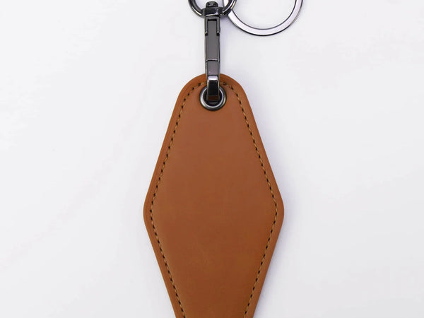 Brown leather keychain with a metal ring on a white background