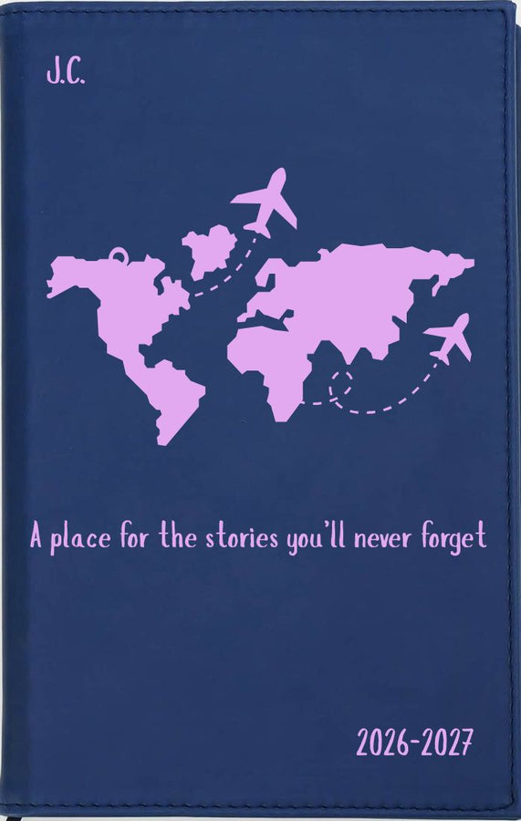 Navy blue planner with pink world map and airplane illustrations on a dark background