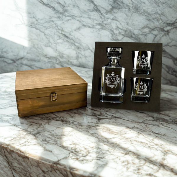 Alcohol decanter and shot glasses with wooden box on marble surface