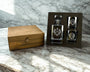 Alcohol decanter and shot glasses with wooden box on marble surface
