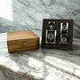 Alcohol decanter and shot glasses with wooden box on marble surface