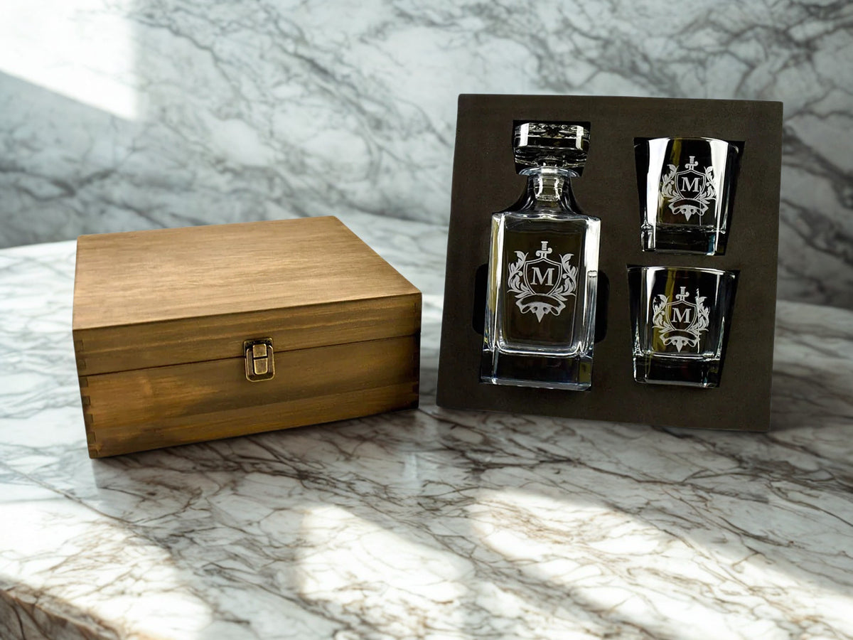 Alcohol decanter and shot glasses with wooden box on marble surface