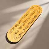 Wooden cribbage board on a beige background