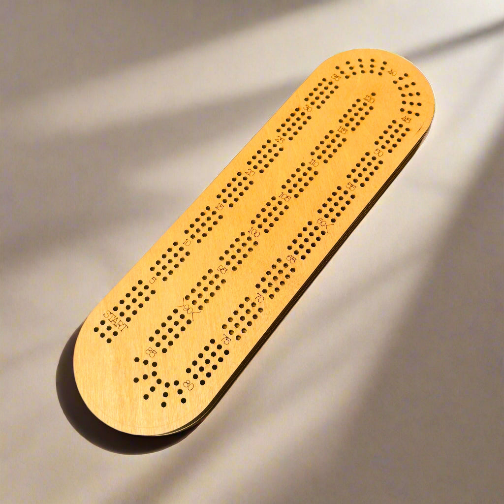Wooden cribbage board on a beige background