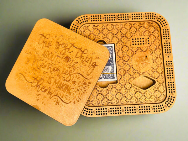 Wooden cribbage board with playing cards on a gray background