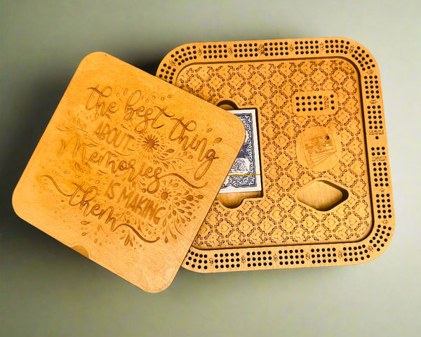 Wooden cribbage board with playing cards on a gray background