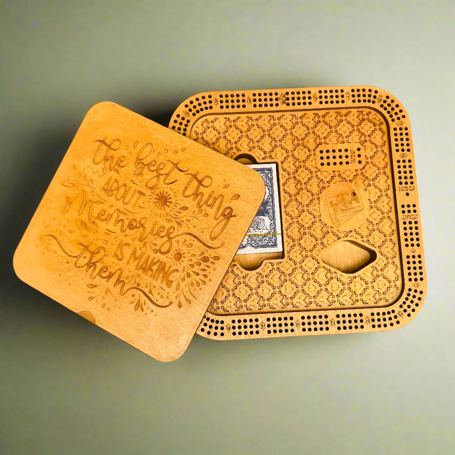 Wooden cribbage board with playing cards on a gray background