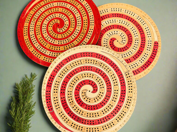 Three circular wooden coasters with spiral designs on a beige background