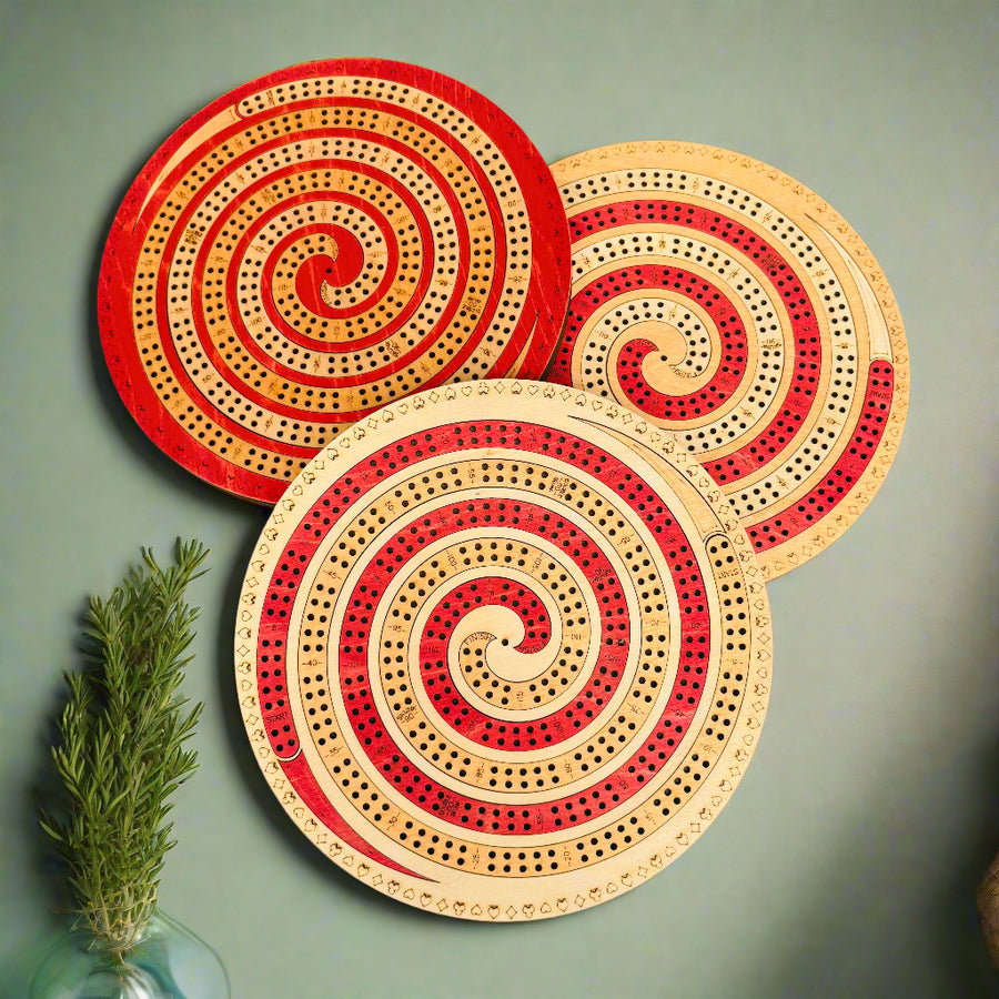 Three circular wooden coasters with spiral designs on a beige background