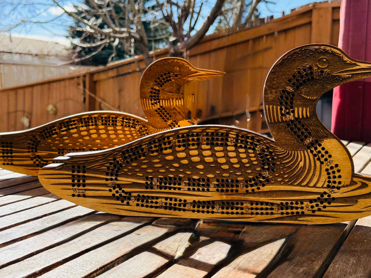 Wooden duck sculpture on a wooden surface outdoors