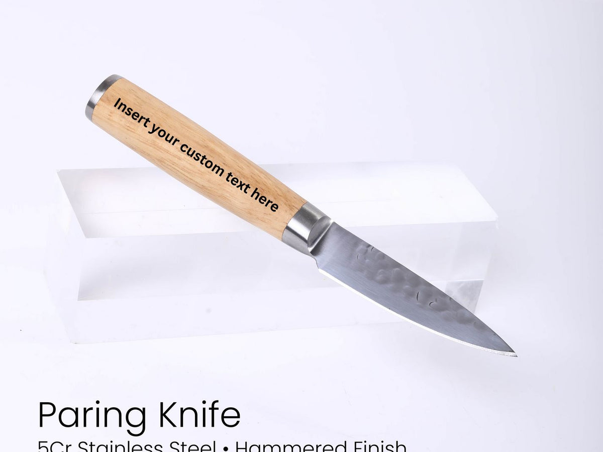 Paring knife with wooden handle on a white background