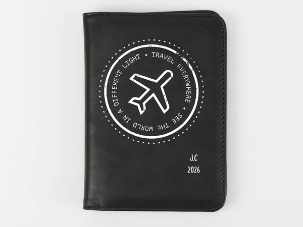 Black passport holder with airplane design and text on a white background