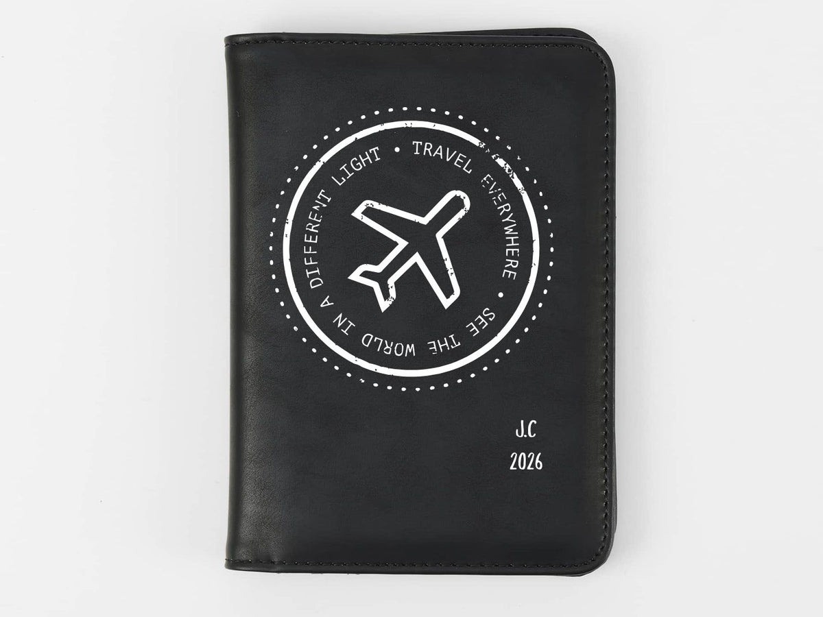 Black passport holder with airplane design and text on a white background