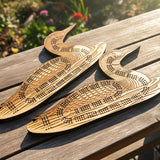 Two wooden swan carvings on a wooden surface