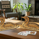 Two wooden duck-shaped carvings on a light stone surface