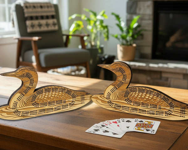 Two wooden duck-shaped carvings on a light stone surface