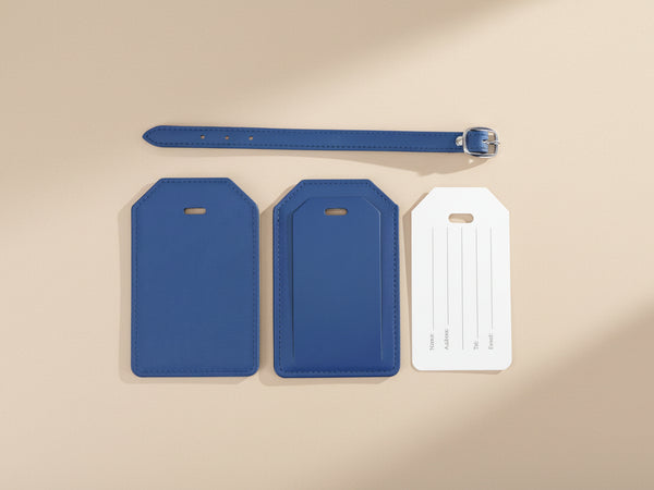 Two blue luggage tags and a belt on a white background