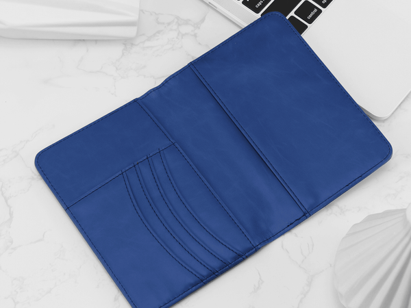 Blue wallet on a white surface with a laptop in the background