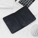 Black leather sleeve on a laptop with a white background
